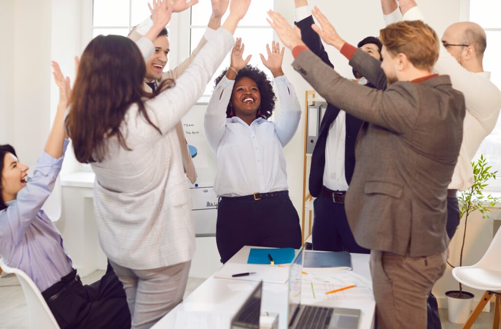 Sales team celebrating success symbolizing unity and teamwork.