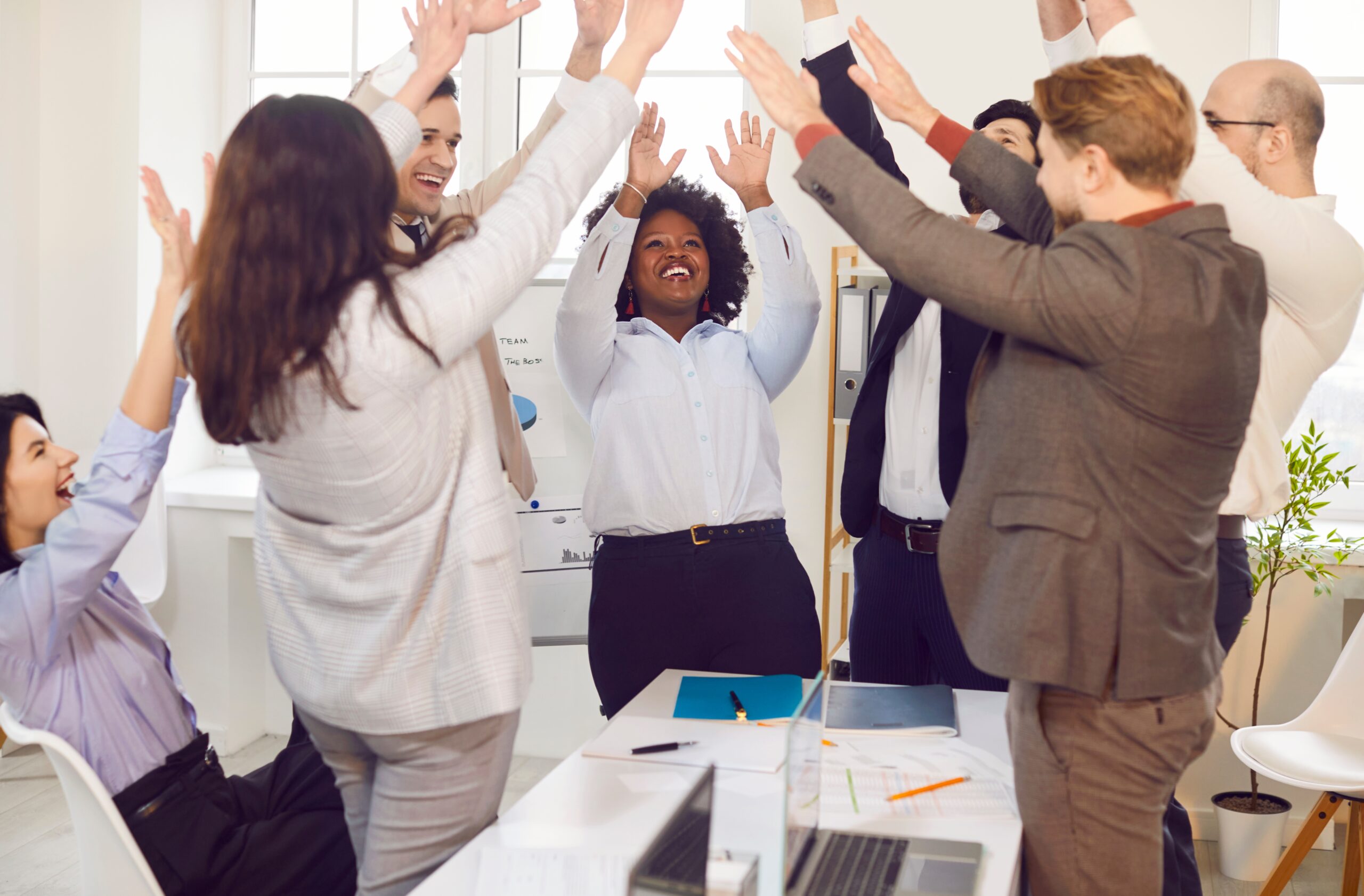 Sales team celebrating success symbolizing unity and teamwork.