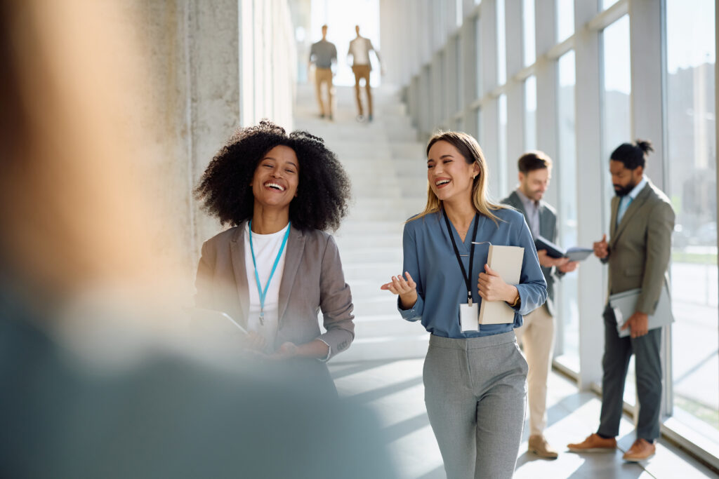 Confident coworkers sharing ideas in a modern workplace while focused on career building.