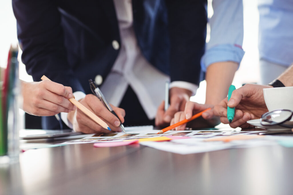 Creative professionals reviewing visuals and ideas during a collaborative brand development session.